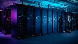 GettyImages 1148233882 300x169 In Data Center: IT Technician Running Maintenance Programme on Laptop, Controls Operational Server Rack Optimal Functioning. Modern High Tech Telecommunications Operational Data Center in Neon Lights.